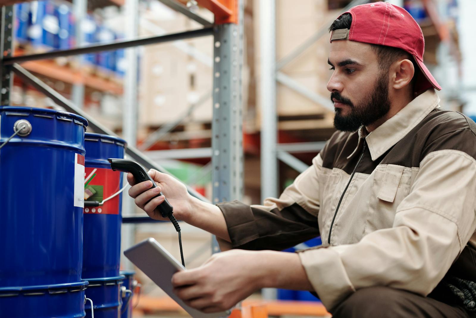 Warehouse worker inspecting incoming FF&E shipment against design specifications