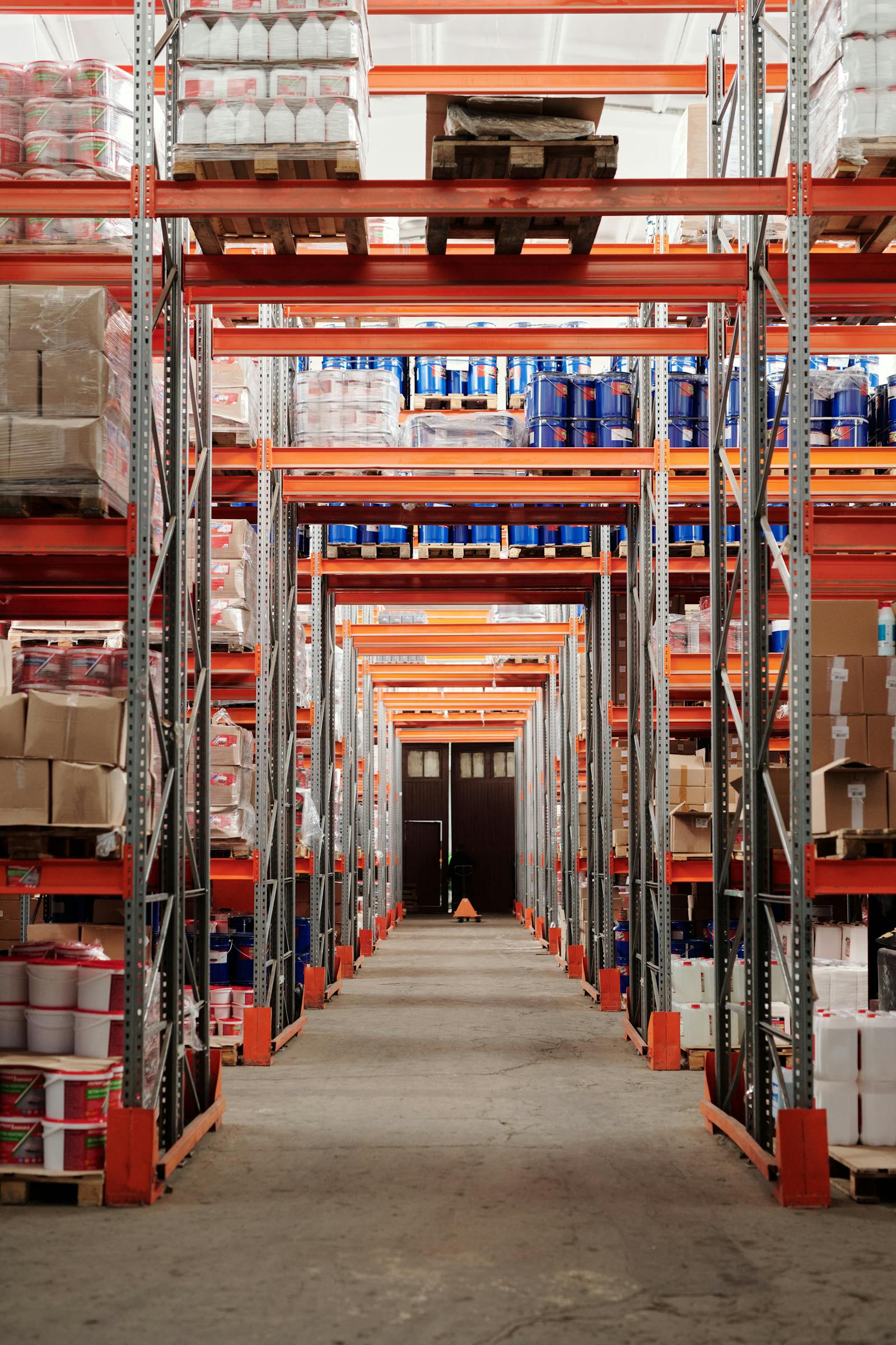 Organized warehouse facility with shelving systems for FF&E storage