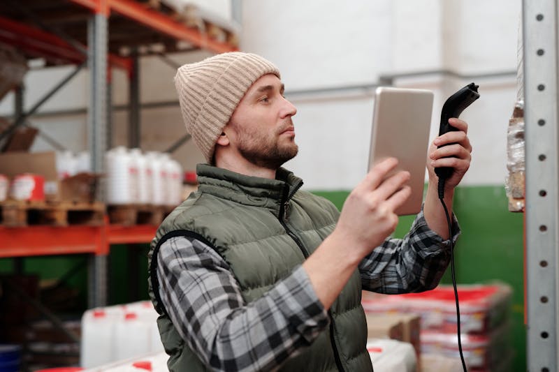 Warehouse worker managing inventory with scanner